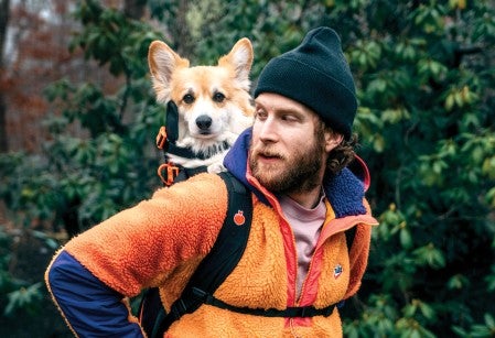 Bryan Reisberg with his corgi, Maxine, strapped into his self-designed backpack.