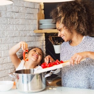 Mother and daughter cooking a plant-based vegan meal together