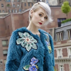fashion model wearing a beautiful blue faux fur coat with flowers, designed by Pelush