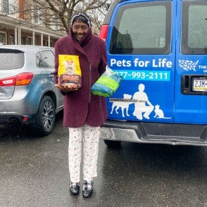 Woman gets pet food from Pets for Life, run by the HSUS