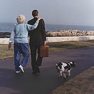 H.W. Bush and Barbara walk with their dogs along the shore