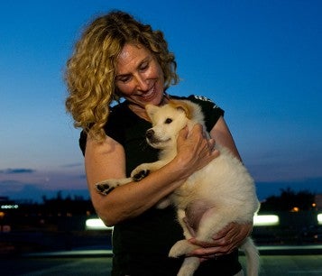 Kitty Block, Acting President and CEO, with a rescue dog from a China dog meat farm