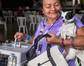 Woman carrying her dog and cat at Spayathon event