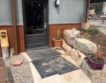 Electric mats on the ground in front of a home's door