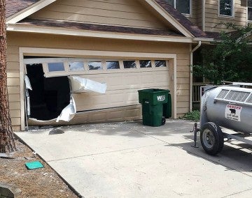 Remains of a garage door busted open by a bear.