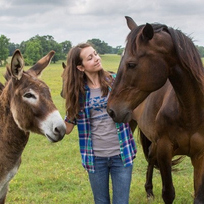 Emma Fuhrmann at with burro and horse at Black Beauty Ranch