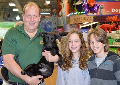 Pennsylvania state senator Daylin Leach and his family meet an adoptable pooch at the grand re-opening of Pets Plus in Conshohocken, Penn.