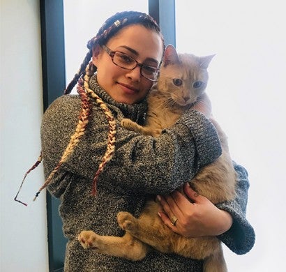 A woman holding her ginger cat