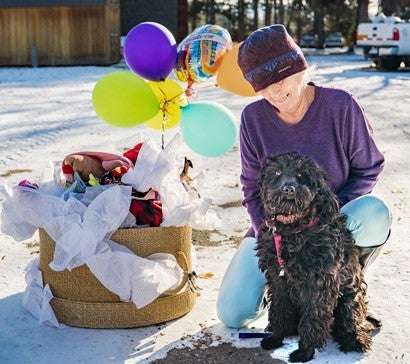 Longtime Pets for Life client Janis celebrates the program’s millionth service: a grooming for her dog, Freeda.