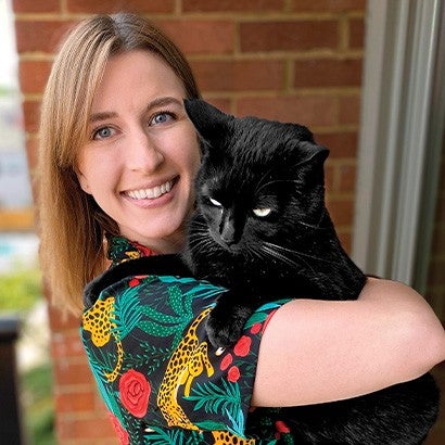 Woman holding a black cat