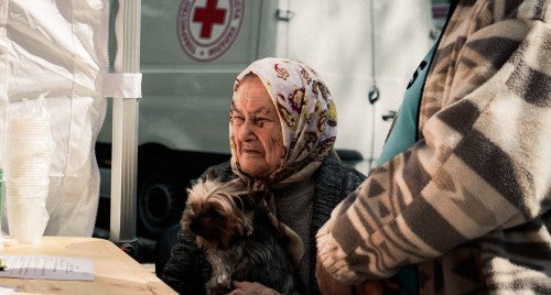 A woman receives aid for her dog