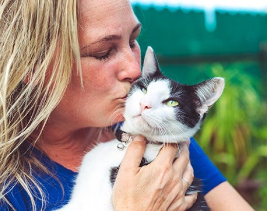 Woman kisses cat