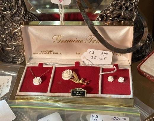 A "Genuine Ivory" labeled pendant, pin, and earrings that sold for $110
