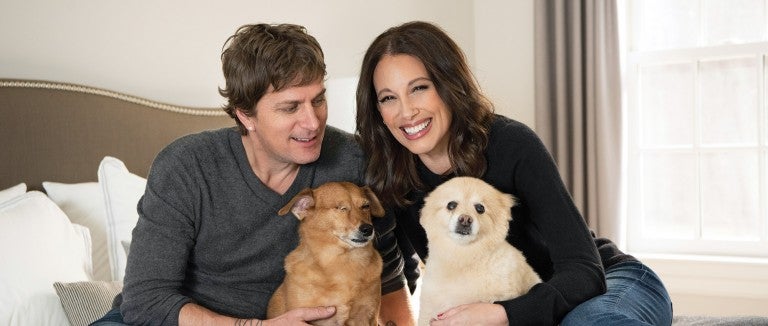 Portrait of Rob and Marisol Thomas with their dogs, Ollie and Samy. 