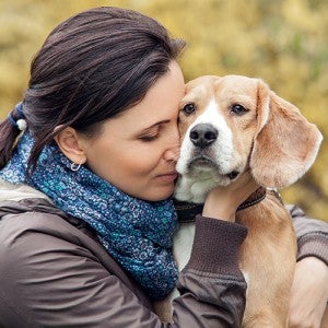 woman nuzzling her dog
