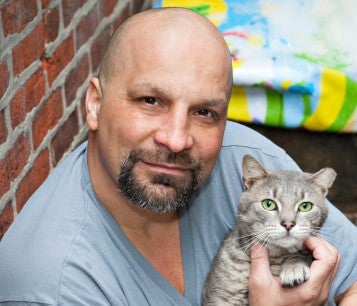 Man holding his grey cat